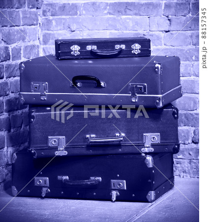 Old vintage suitcases isolated near brick wall Old vintage suitcases isolated near brick wall 88157345