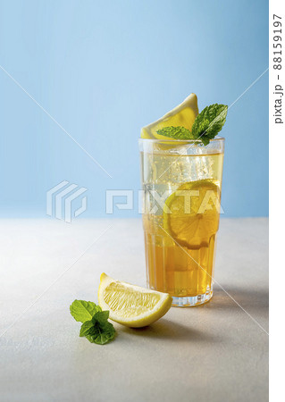 Iced tea with lemon and fresh mint, blue background Iced tea with lemon and fresh mint, blue background 88159197