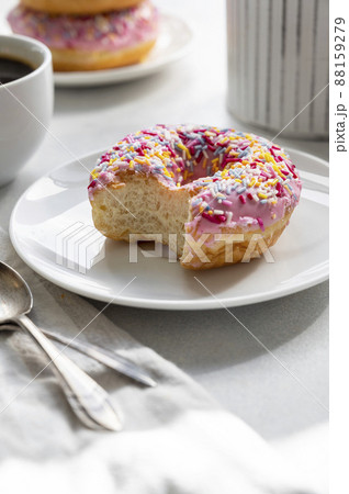 Pink donut with sprinkles and coffee cup for breakfast Pink donut with sprinkles and coffee cup for breakfast 88159279