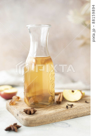 chilled apple tea with honey and cinnamon in a glass bottle, close-up 88159894
