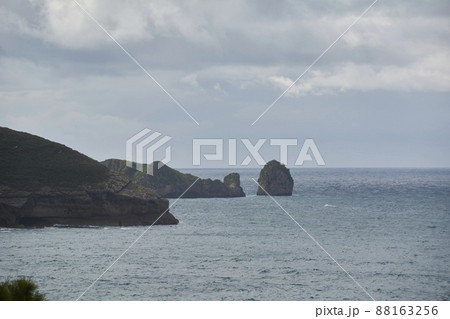 Rocky beach with gray clouds after the storm. Rocky beach with gray clouds after the storm. 88163256