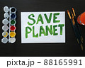 The poster with the call to save the planet is painted in bright green paint on white sheet. Rally, appeal, picket 88165991