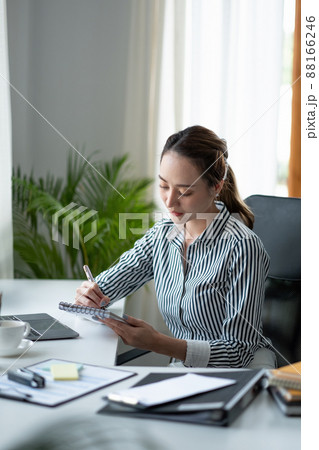 Business asian hand holding pencil and writing note on wood table,Checklist Notice Remember Planning Concept Business asian hand holding pencil and writing note on wood table,Checklist Notice Remember Planning Concept 88166246