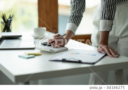 Close up Business woman using calculator and laptop for do math finance on wooden desk, tax, accounting, statistics and analytical research concept Close up Business woman using calculator and laptop for do math finance on wooden desk, tax, accounting, statistics and analytical research concept 88166275