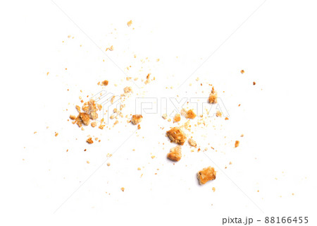 Scattered crumbs of vanilla chip butter cookies isolated on white background. Close-up view of brown crackers. Macro shot of yellow biscuit cake leftovers for your design Scattered crumbs of vanilla chip butter cookies isolated on white background. Close-up view of brown crackers. Macro shot of yellow biscuit cake leftovers for your design 88166455