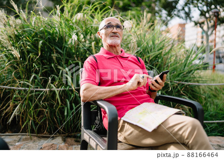 Serious male using phone sitting on chair 88166464