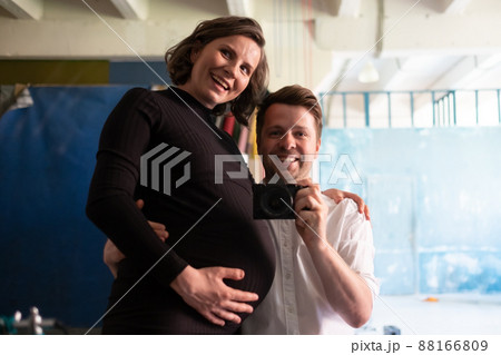 Waiting for baby. Happy caucasian man hugging his pregnant woman Waiting for baby. Happy caucasian man hugging his pregnant woman 88166809
