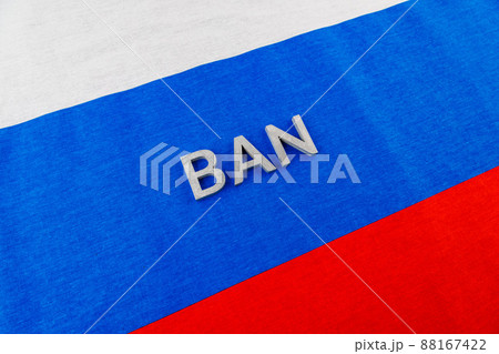 the word ban laid with silver metal letters over fabric Russian Federation flag 88167422
