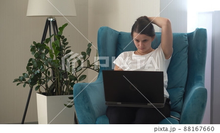 Authentic Stressful Woman working Chatting On Laptop Living Room. Writing Searching Using IT. Tired Sad Lady Working On Computer Internet On Comfortale Chair. Buisenes, Education, Technology Concept 88167660