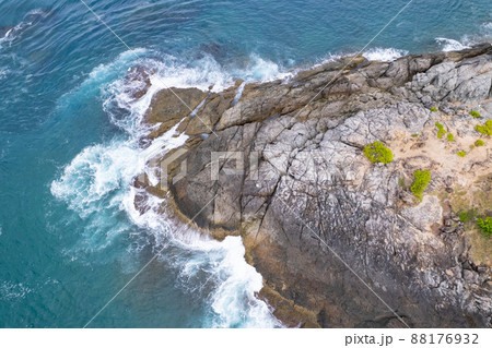 Aerial view Top down seashore big wave crashing on rock cliff Beautiful dark sea surface in sunny day summer background Amazing seascape top view seacoast at Phuket Thailand 88176932