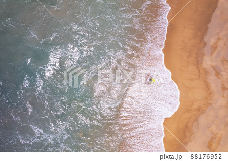 Aerial view top down of Local southern Thai fisherman uses his handmade fish trap and cicada sea on a beach in Phuket Thailand.Beautiful waves crashing on beach Aerial view top down of Local southern Thai fisherman uses his handmade fish trap and cicada sea on a beach in Phuket Thailand.Beautiful waves crashing on beach 88176952