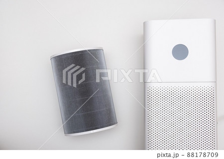 Indoor air purifier of white color close-up on a white background. Dust and allergy cleaner in the house. 88178709