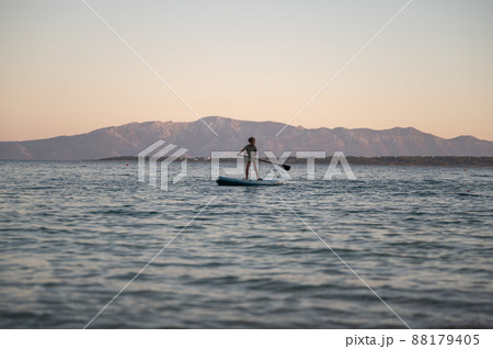 Schoolboy standing on a sup board Schoolboy standing on a sup board 88179405