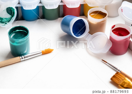 Set of color paint cans and brushes for painting on white paper background. Hobby and education concept 88179693
