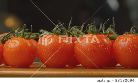 Fresh tomatoes on the wooden cutting board 88180094