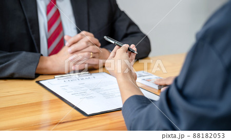 Bribe employer is handing over a pen and offer terms to businessman for signing on contract while making corruption Bribe employer is handing over a pen and offer terms to businessman for signing on contract while making corruption 88182053