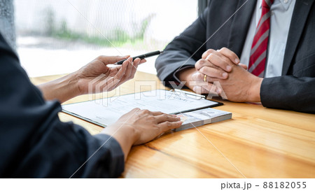 Bribe employer is handing over a pen and offer terms to businessman for signing on contract while making corruption 88182055