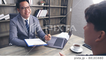 Businessman job interview by human resource HR officer interviwing, talk new employee shaking hands in office with smiling face. HR Manager interview check resume, face to face. Job Interview Concept Businessman job interview by human resource HR officer interviwing, talk new employee shaking hands in office with smiling face. HR Manager interview check resume, face to face. Job Interview Concept 88183880