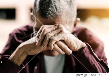 senior man covering his face with his hands.vintage tone. 88184507