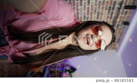 Vertical photo, the girl presses the record button on her smartphone and keeps a blog. Social network. Blogger Vertical photo, the girl presses the record button on her smartphone and keeps a blog. Social network. Blogger 88185583