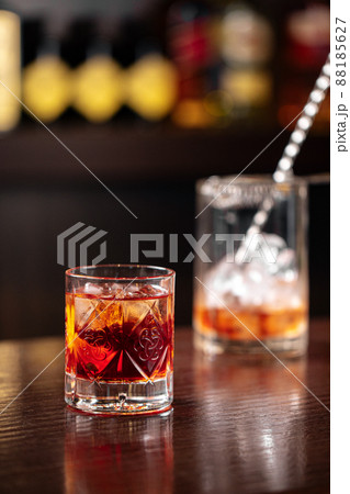 Crystal glass of classic negroni cocktail with ice 88185627
