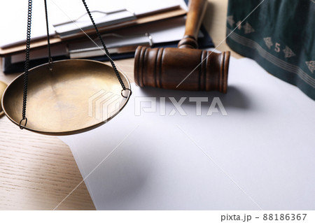 Paper with words DOMESTIC VIOLENCE and scale on wooden table. Protection of law Paper with words DOMESTIC VIOLENCE and scale on wooden table. Protection of law 88186367