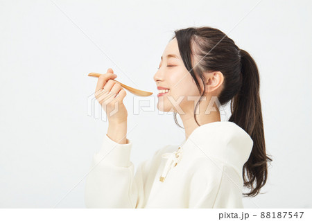スプーンで食事をする女性 88187547