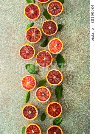 Blood orange halves with spinach leaves Blood orange halves with spinach leaves 88190034
