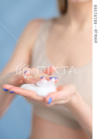 Foam for washing in women's hands close-up. Foam for washing in women's hands close-up. 88191568