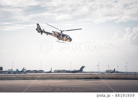 Military helicopter performing exercise at low altitude Military helicopter performing exercise at low altitude 88191939