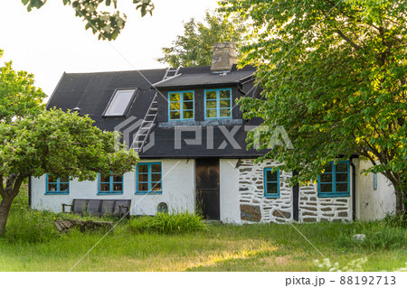 Image of beautiful garden with apple trees, flowers and scandinavian style summer house 88192713