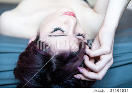 Portrait of a 23 year old white woman, lying on a bed Portrait of a 23 year old white woman, lying on a bed 88193655
