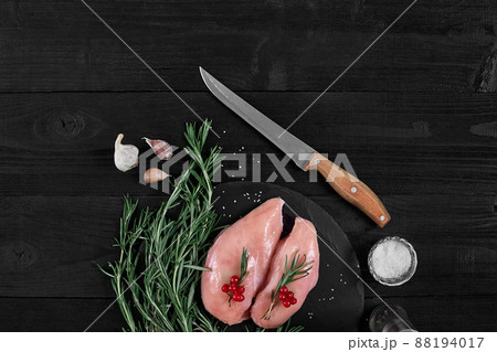 Cooking chicken breasts. On the table are spices - rosemary, red and black pepper. Concept - healthy food. 88194017