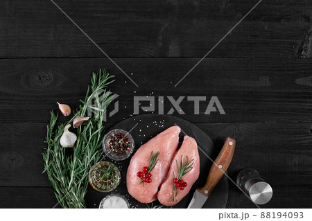 Raw chicken fillet with cooking ingredients on black slate table. Food background. Top view, copy space. Raw chicken fillet with cooking ingredients on black slate table. Food background. Top view, copy space. 88194093