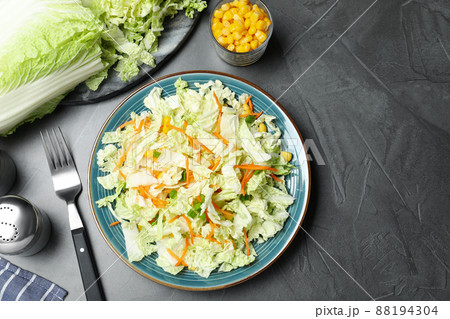 Fresh cabbage salad with carrot served on grey table, flat lay Fresh cabbage salad with carrot served on grey table, flat lay 88194304