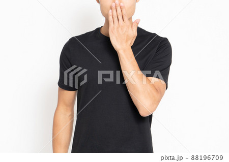 白い背景の前に立って内緒のジェスチャーをする男性 88196709