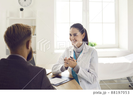 Smiling female doctor consult male patient Smiling female doctor consult male patient 88197053