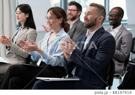 Two rows of happy employees clapping hands to speaker after presentation 88197919