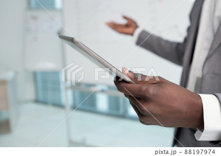 Hand of young African American lecturer holding tablet during presentation 88197974