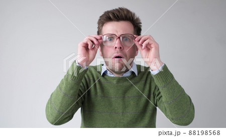 Man with wide eyes and mouth open in surprise with a surprised and shocked face Man with wide eyes and mouth open in surprise with a surprised and shocked face 88198568