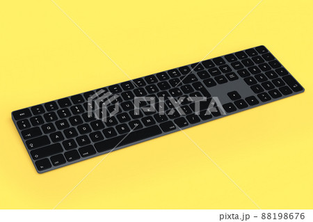 Modern dark aluminum computer keyboard isolated on yellow background. Modern dark aluminum computer keyboard isolated on yellow background. 88198676