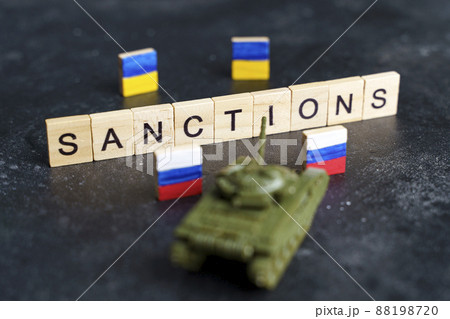Sanctions against Russia concept. Toy tank and the inscription Sanctions on a dark background. Selected focus. War conflict in Ukraine, default, economic and monetary crisis in Russia. Sanctions against Russia concept. Toy tank and the inscription Sanctions on a dark background. Selected focus. War conflict in Ukraine, default, economic and monetary crisis in Russia. 88198720