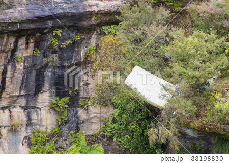 Photograph of a large bed mattress thrown into a ravine as rubbish. Photograph of a large bed mattress thrown into a ravine as rubbish. 88198830