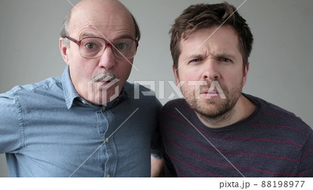 Surprised two men have scared expressions can not believe their eyes. Surprised two men have scared expressions can not believe their eyes. 88198977