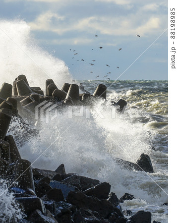 Waves crash on a breakwater during winter storms Waves crash on a breakwater during winter storms 88198985