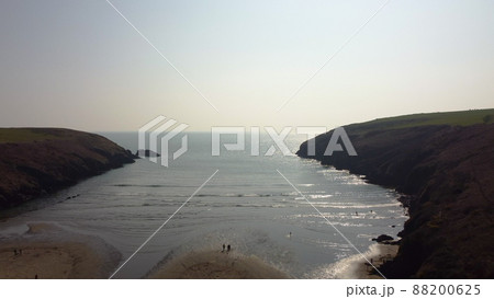 aerial drone flight over Stradbally Cove, Atlantic Ocean beach on the Cooper Coast, Waterford, Ireland. aerial drone flight over Stradbally Cove, Atlantic Ocean beach on the Cooper Coast, Waterford, Ireland. 88200625