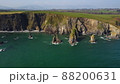 huge rocks and cliffs in the middle of the Atlantic Ocean in a UNESCO protected geopark, Stradbally Cove, on the Cooper Coast, Waterford, Ireland. 88200631