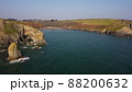 sideways movement of drone over the Atlantic Ocean. flying over cliffs and a blue sea. Stradbally Cove, Cooper Coast, Waterford, Ireland. 88200632