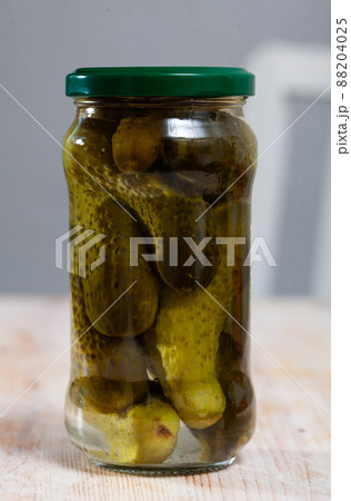 Glass jar of pickled cucumbers Glass jar of pickled cucumbers 88204025