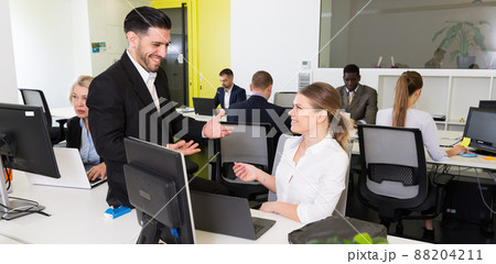 Coworkers flirting in modern office 88204211